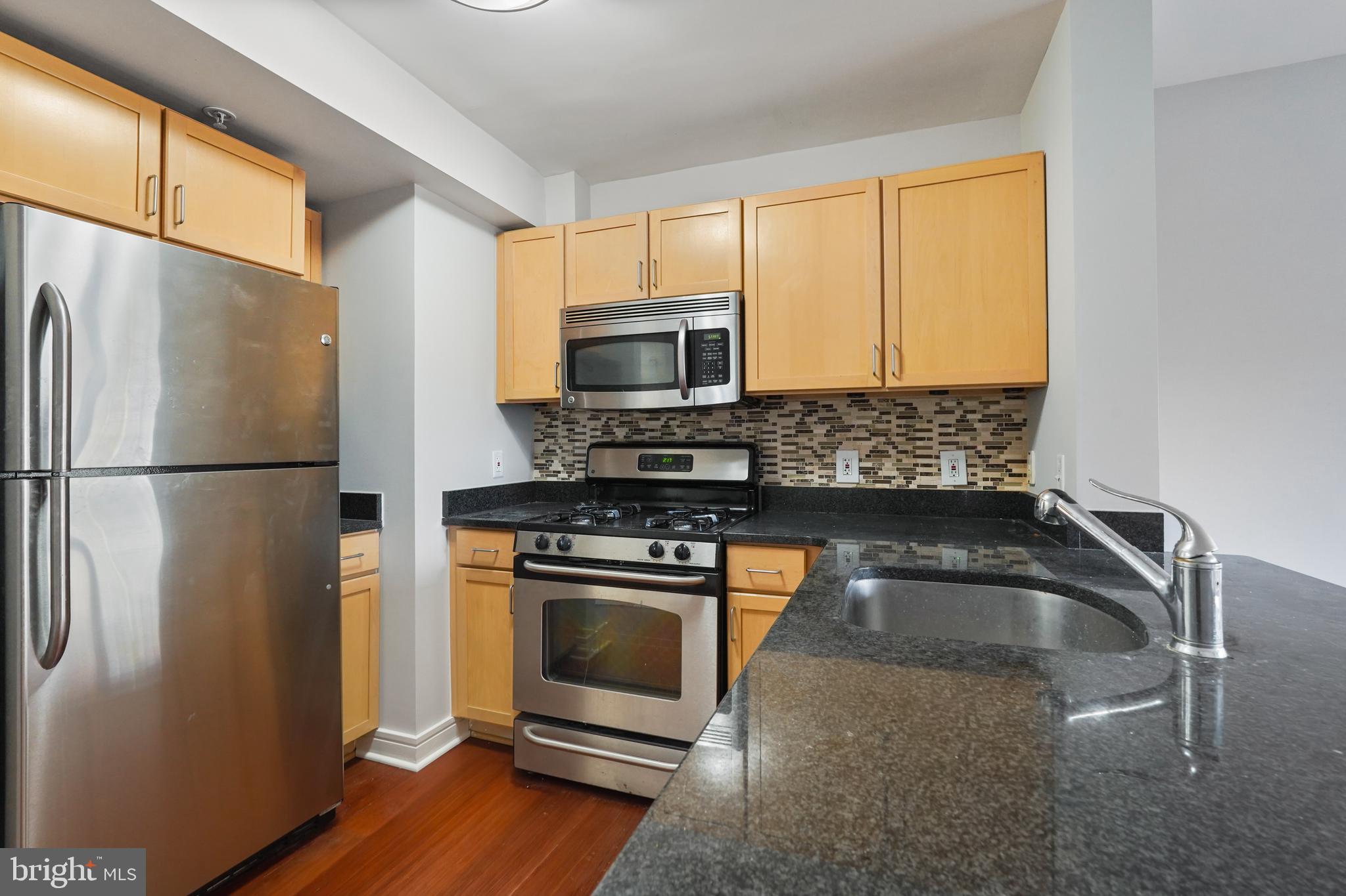 800 4th Street Southwest, Unit N111 Washington, DC 20024 - Photo 6 of 27 a kitchen with appliances a counter space and a window