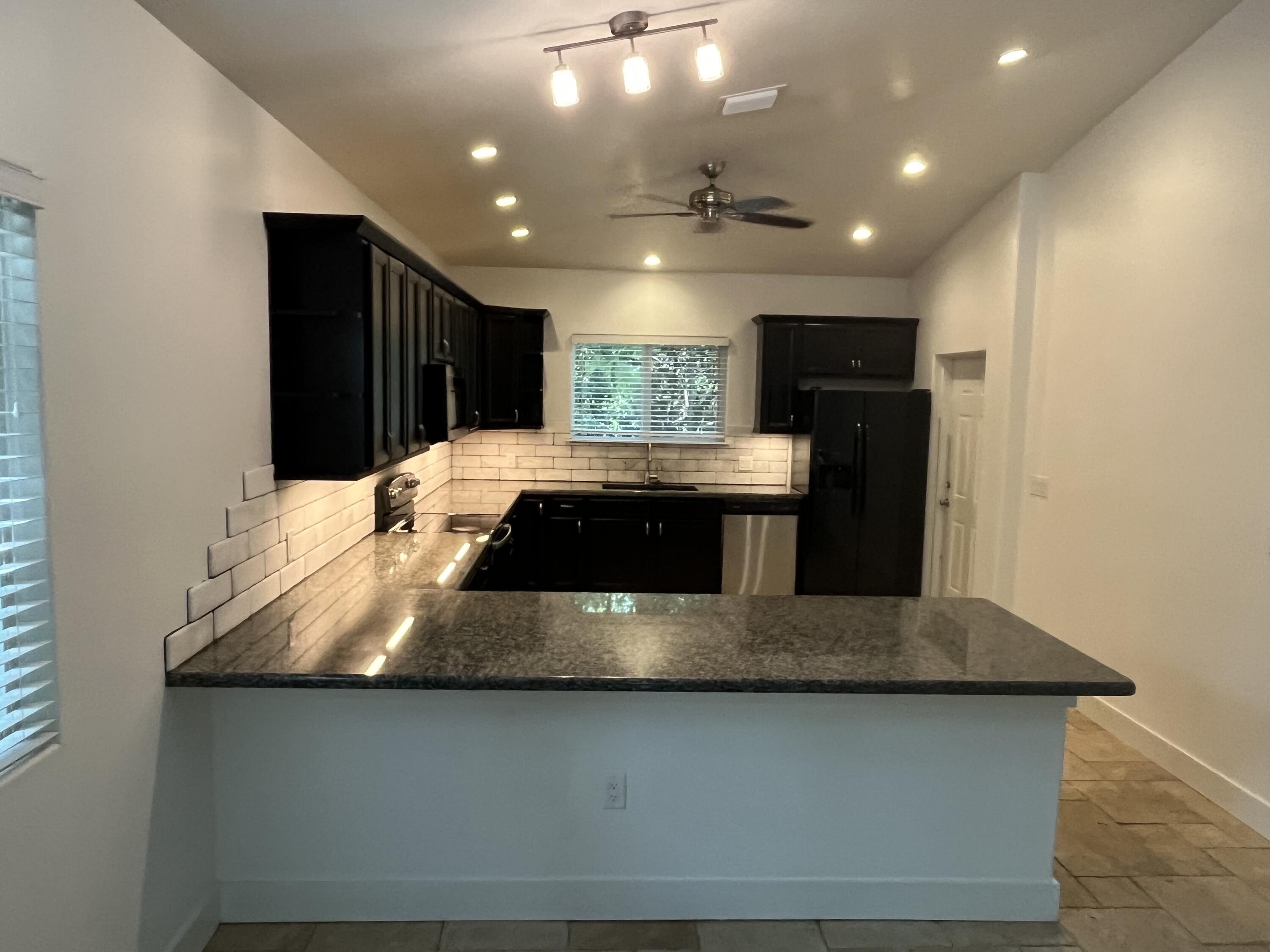 639 Cabrera Street Key Largo, FL 33037 - Photo 10 of 24 a view of kitchen island a sink and a refrigerator