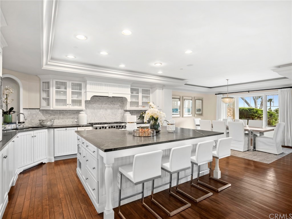3 Stickley Drive Laguna Beach, CA 92651 - Photo 6 of 39 a kitchen with kitchen island granite countertop lots of white cabinets a sink and appliances