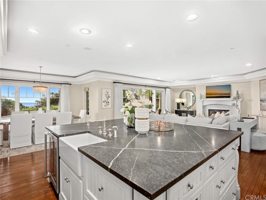3 Stickley Drive Laguna Beach, CA 92651 - Photo 8 of 39 a view of kitchen island a sink and living room with wooden floor
