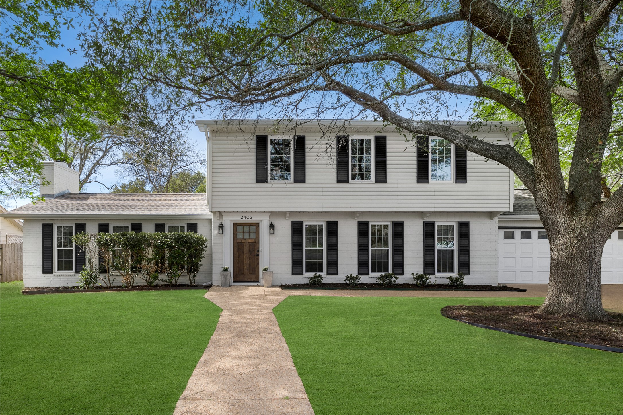 2403 Comburg Castle Way Austin, TX 78748 - Photo 1 of 40 Colonial house featuring brick siding, a front lawn, a chimney, and a garage