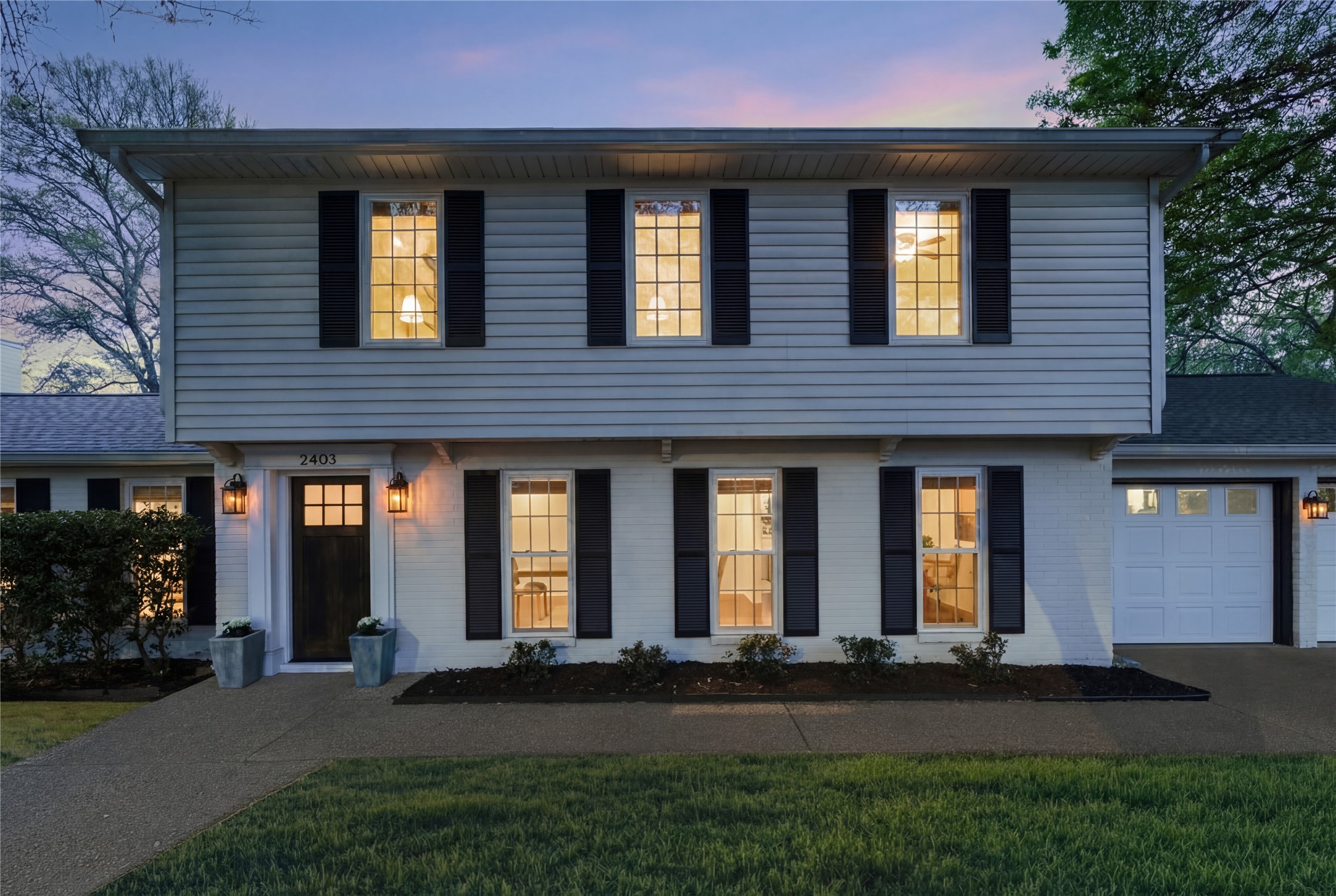 2403 Comburg Castle Way Austin, TX 78748 - Photo 3 of 40 Colonial home featuring an attached garage, brick siding, a lawn, and driveway