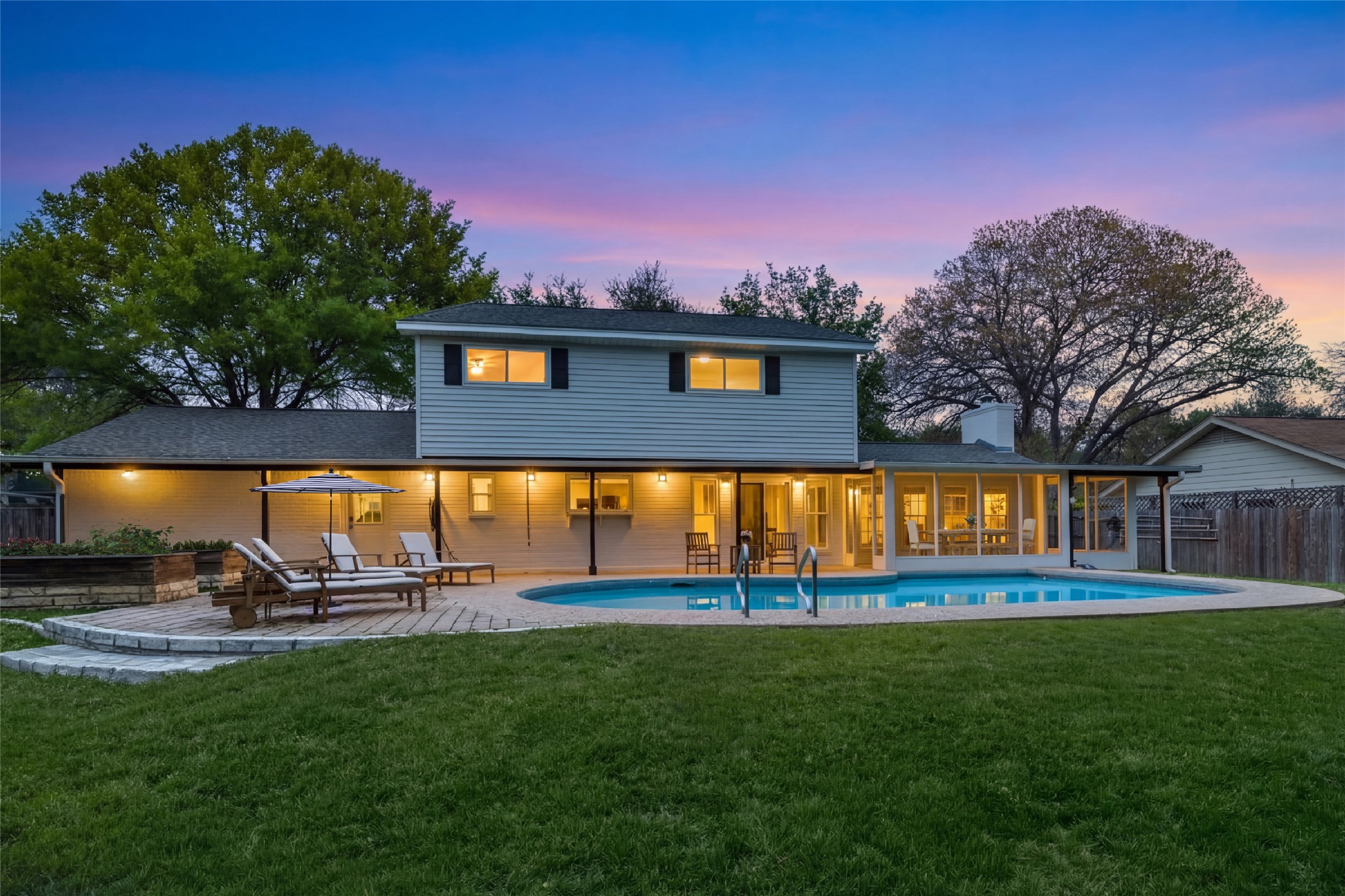 2403 Comburg Castle Way Austin, TX 78748 - Photo 31 of 40 Back of property at dusk featuring a patio area and a chimney