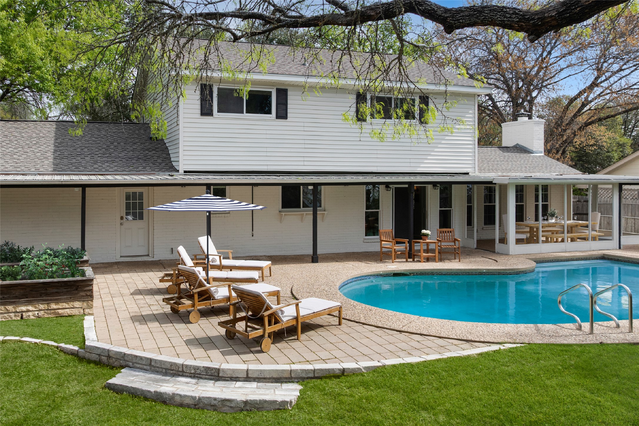 2403 Comburg Castle Way Austin, TX 78748 - Photo 36 of 40 Back of house with a patio area, roof with shingles, a chimney, and an outdoor pool