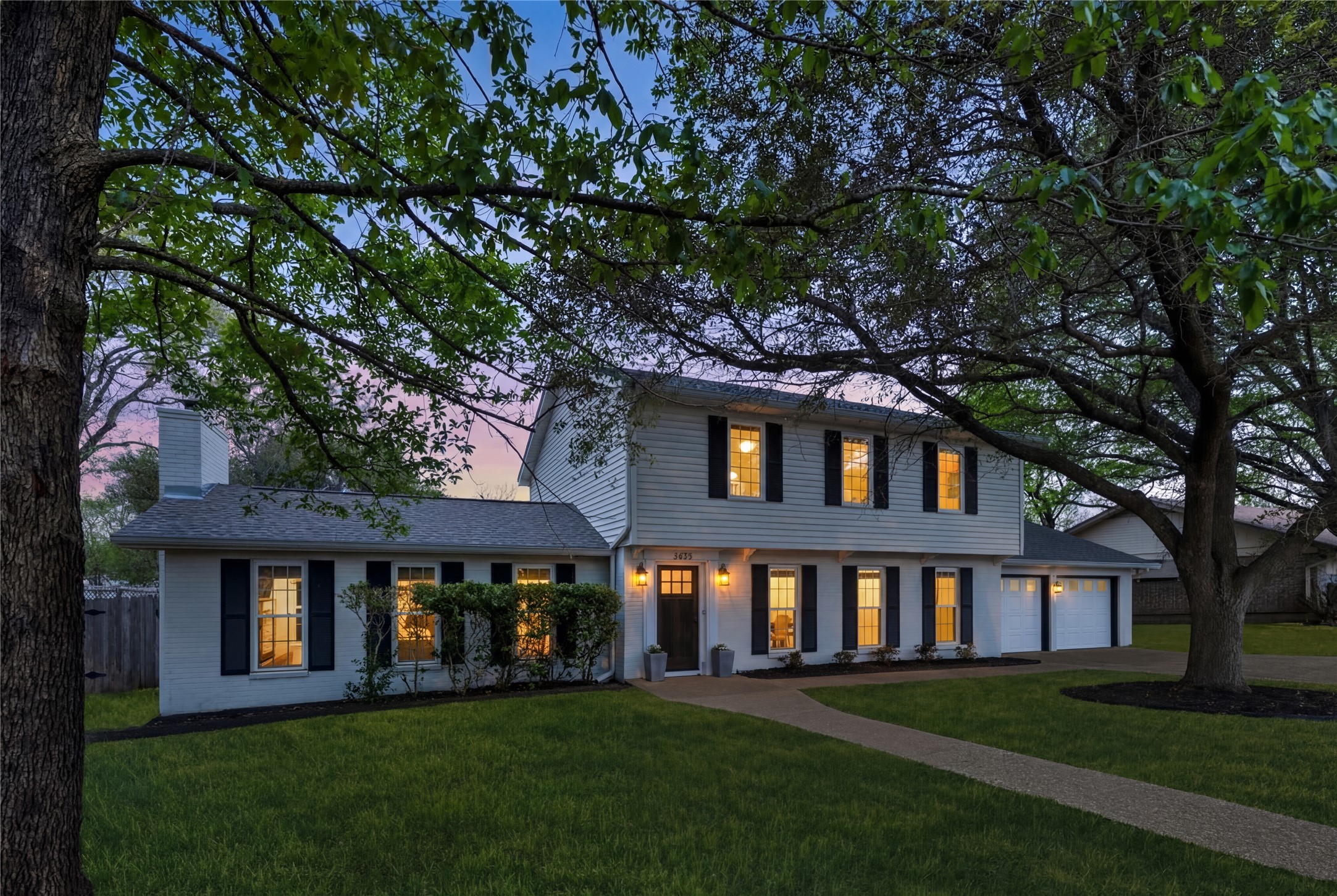 2403 Comburg Castle Way Austin, TX 78748 - Photo 4 of 40 View of front of home with a front yard, driveway, and a chimney