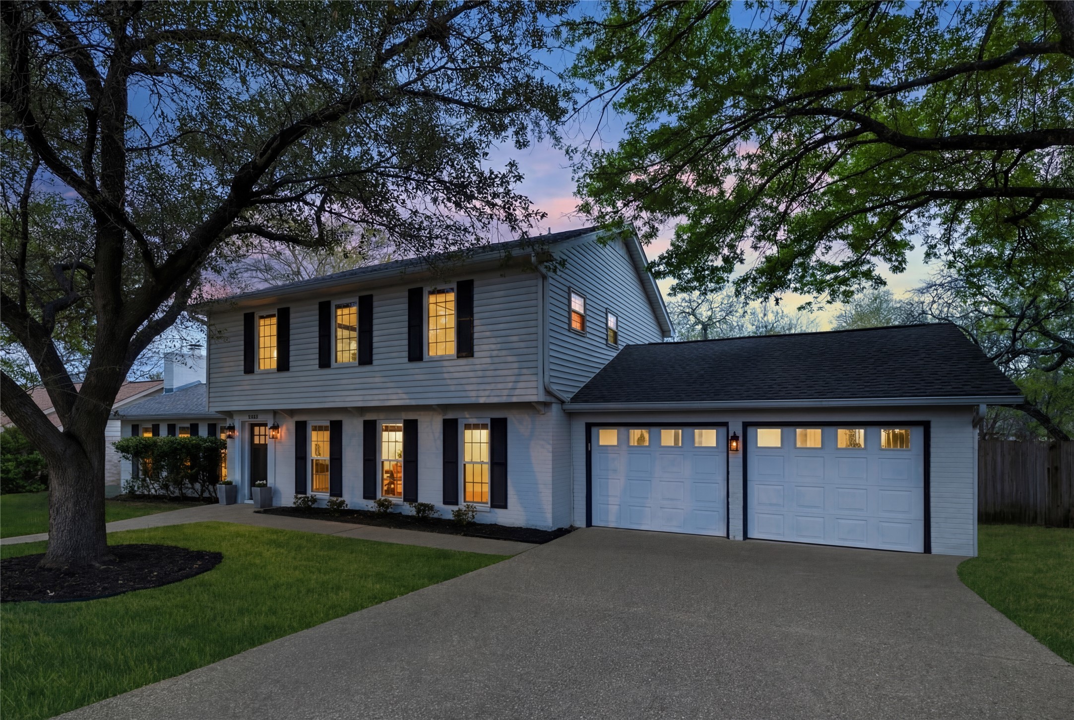 2403 Comburg Castle Way Austin, TX 78748 - Photo 6 of 40 Colonial inspired home featuring an attached garage, driveway, roof with shingles, and covered porch