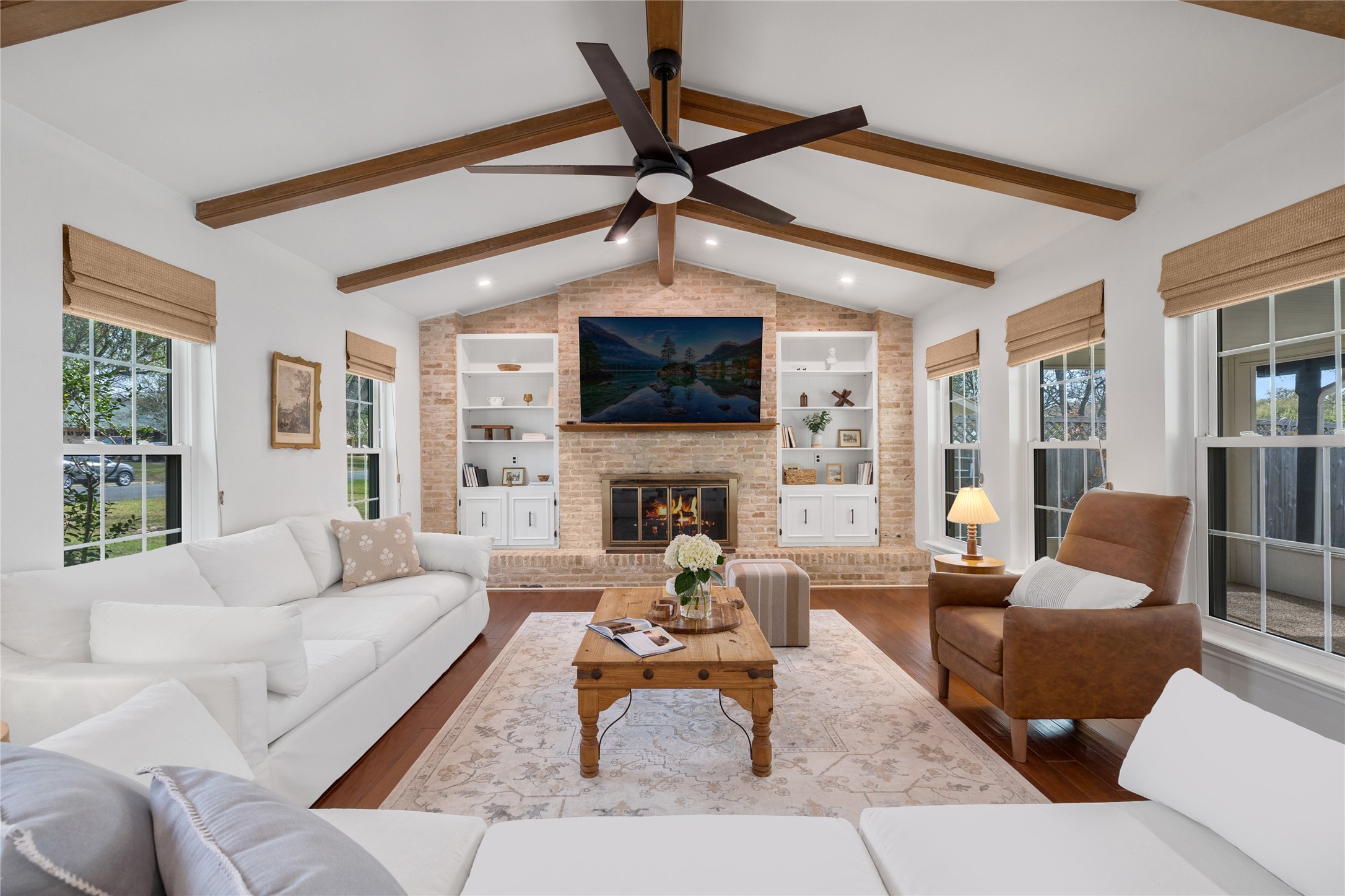 2403 Comburg Castle Way Austin, TX 78748 - Photo 8 of 40 Living room with dark wood-type flooring, a brick fireplace, ceiling fan, recessed lighting, and built in shelves