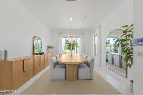 a living room with furniture and a large window with kitchen view