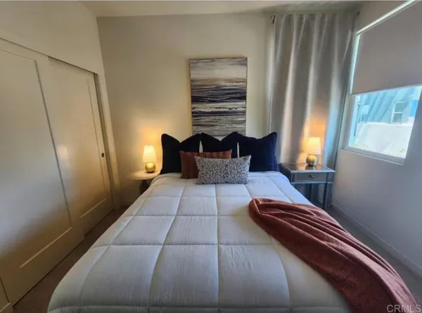 a bedroom with a bed and a window