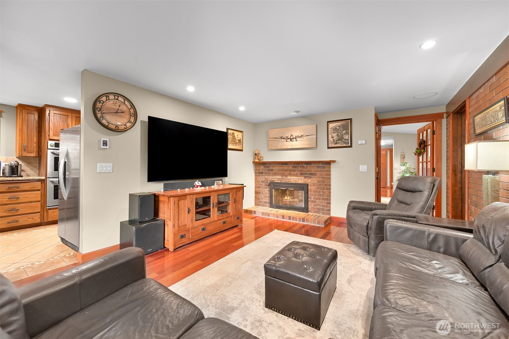 214 Bayside Place Bellingham, WA 98225 - Photo 24 of 40 a living room with furniture a flat screen tv and a fireplace