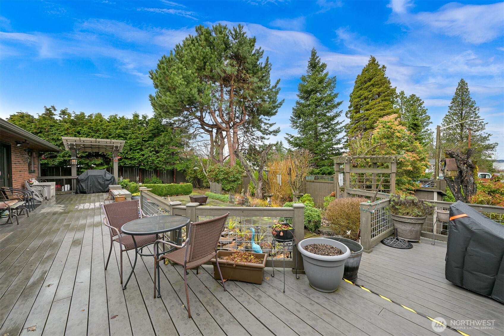 214 Bayside Place Bellingham, WA 98225 - Photo 30 of 40 a view of a deck with table and chairs and potted plants