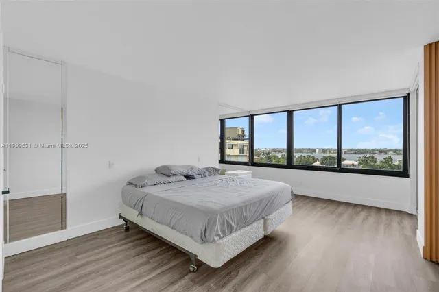a bedroom with a large bed and a large window