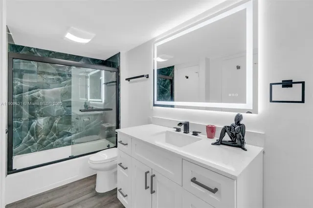 a bathroom with a sink a mirror and a shower