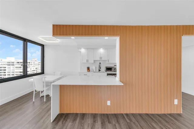 a view of a livingroom with wooden floor and furniture