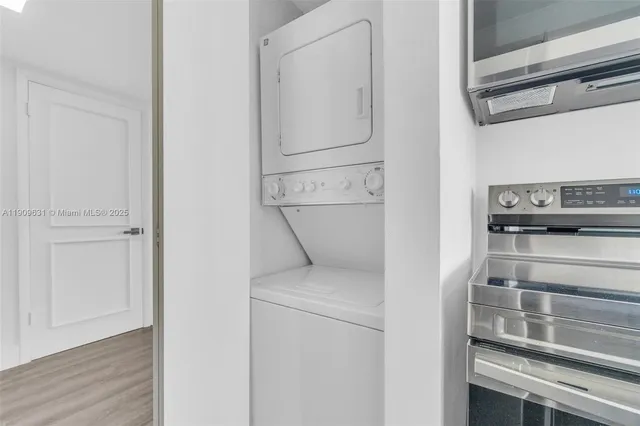 an aerial view of a house with a yard and a large tree