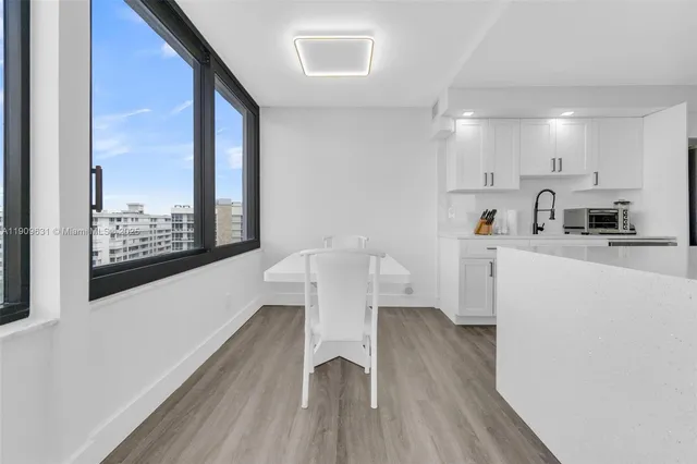 a view of kitchen with cabinets and wooden floor
