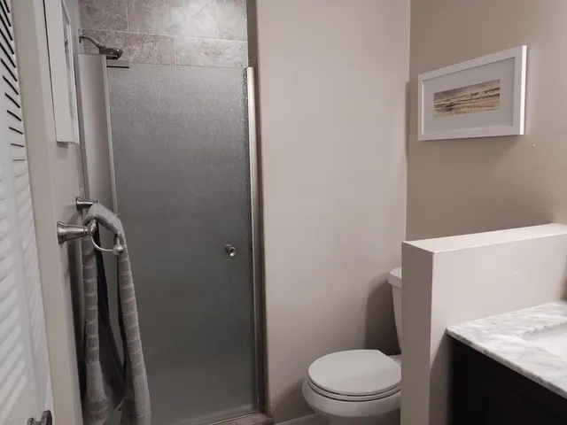 a white toilet sitting next to a bathroom sink