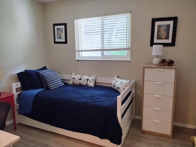 a bedroom with a bed and a window