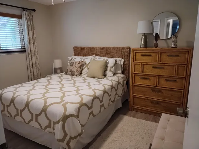 a bedroom with a bed and a mirror