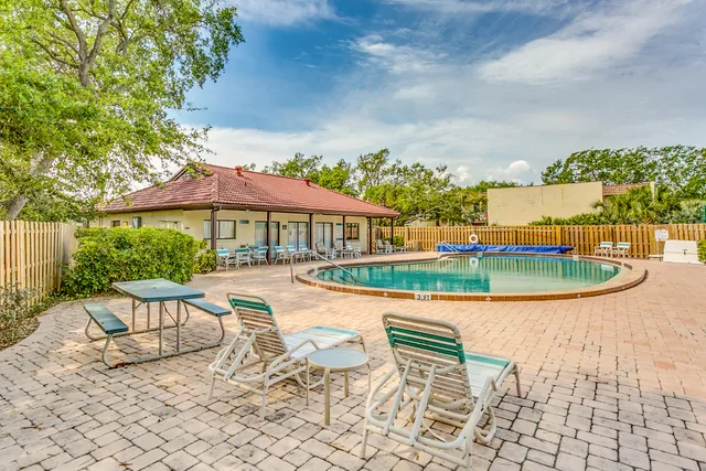 an outdoor space with pool and furniture
