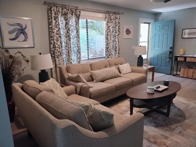 a living room with furniture and a large window