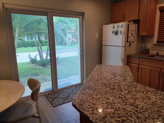 a kitchen with a refrigerator and a stove