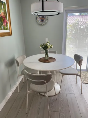 a dining room with table and chairs