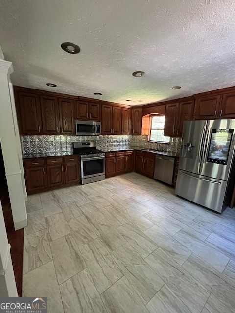 1221 Martin Nash Road Southwest Lilburn, GA 30047 - Photo 14 of 31 a large kitchen with granite countertop a stove and cabinets