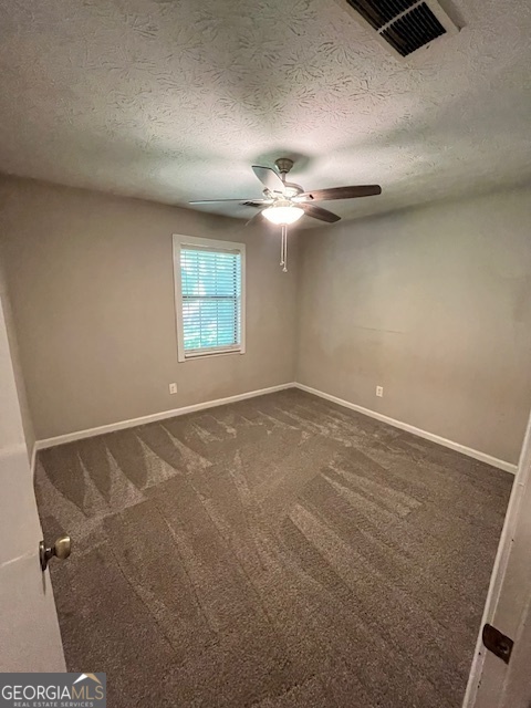 1221 Martin Nash Road Southwest Lilburn, GA 30047 - Photo 21 of 31 an empty room with windows and fan
