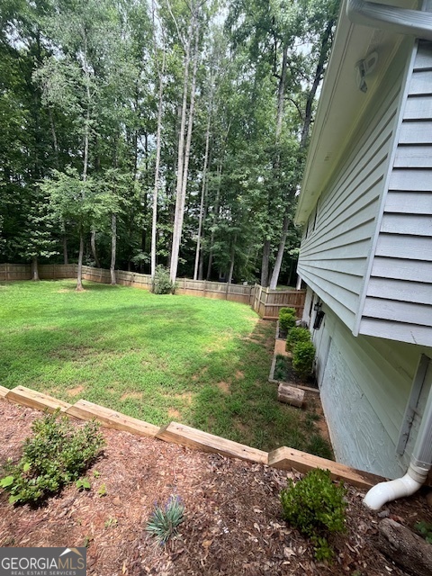 1221 Martin Nash Road Southwest Lilburn, GA 30047 - Photo 4 of 31 a view of a backyard with a swing