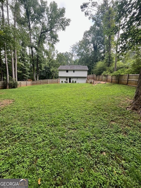 1221 Martin Nash Road Southwest Lilburn, GA 30047 - Photo 6 of 31 a view of a backyard with a garden