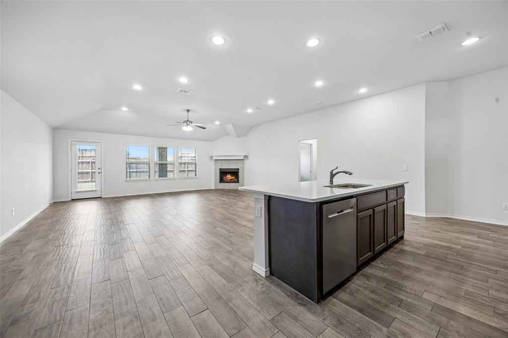 3807 Dogwood Road Melissa, TX 75454 - Photo 10 of 38 a kitchen with stainless steel appliances granite countertop a large counter top and wooden floors