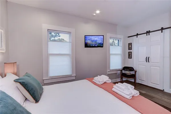 a bedroom with a bed and a chair