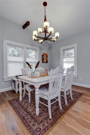 a view of a dining room with furniture wooden floor and chandelier