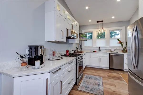a kitchen with a sink microwave and cabinets