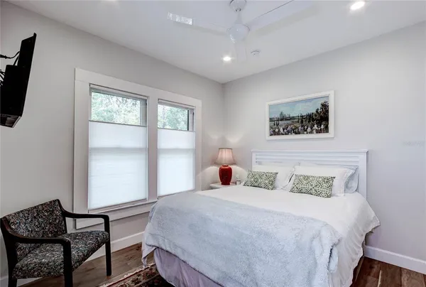 a bedroom with a bed a couch and a window