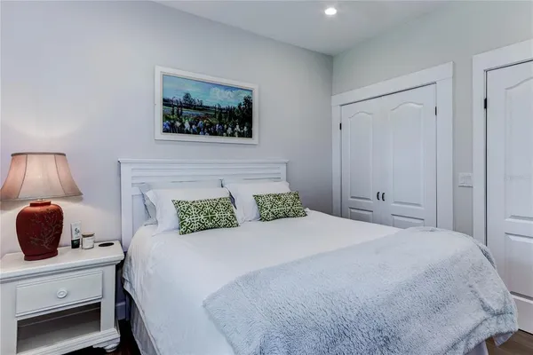 a bedroom with a bed and a lamp