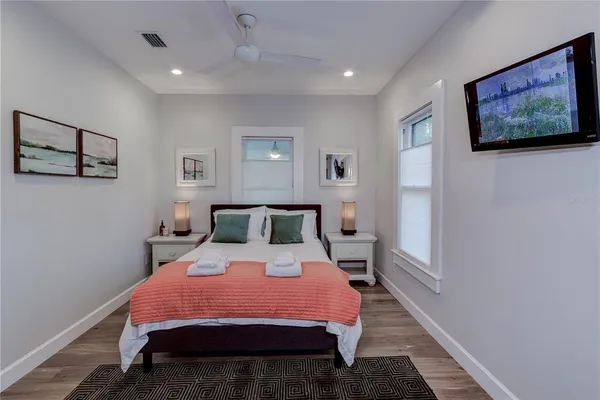 a bedroom with a bed and a painting on the wall