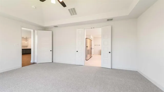 a spacious bathroom with a double vanity sink toilet mirror and bathtub