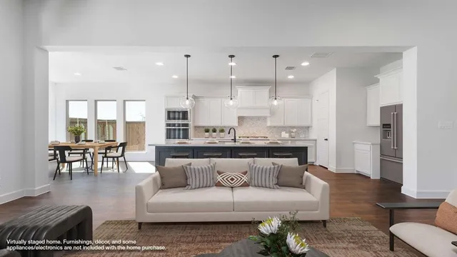 a living room with furniture kitchen view and a dining table