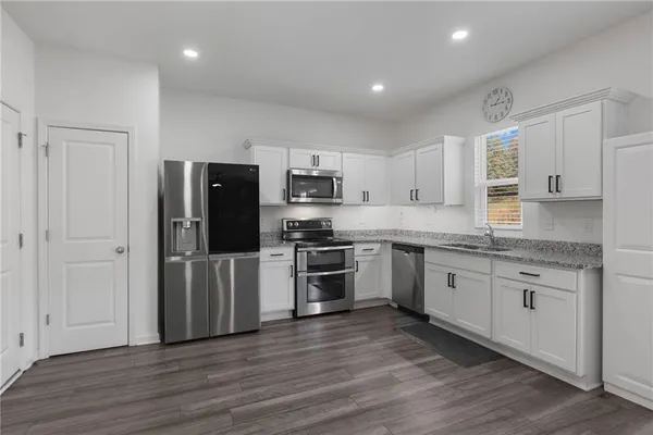 a kitchen with a refrigerator and a stove top oven