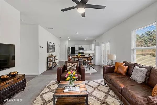a living room with furniture and a flat screen tv