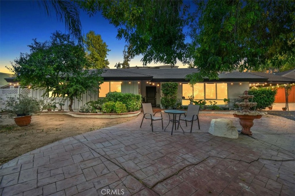 5064 Myrtle Avenue Riverside, CA 92506 - Photo 1 of 1 a view of a patio with table and chairs potted plants and large tree