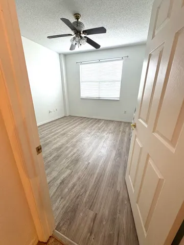 a view of an empty room and wooden floor