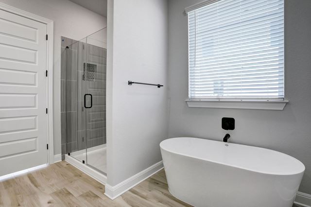 17309 Howdy Way Manor, TX 78653 - Photo 7 of 12 a white bath tub sitting next to a shower