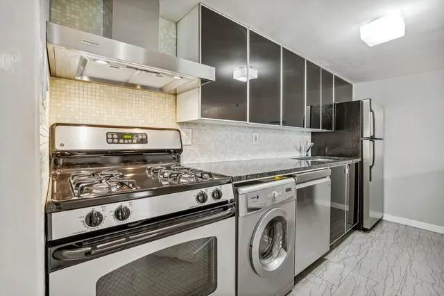 a stove top oven sitting inside of a kitchen