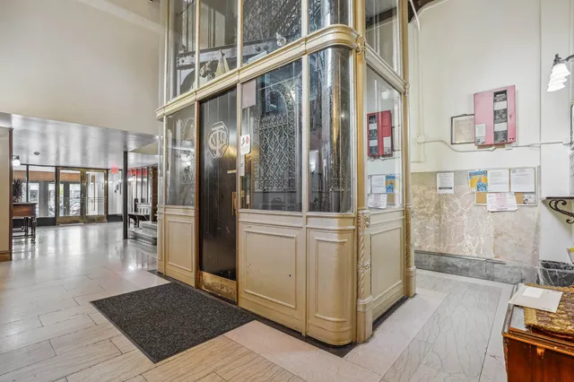 a view of an empty room with furniture and stairs