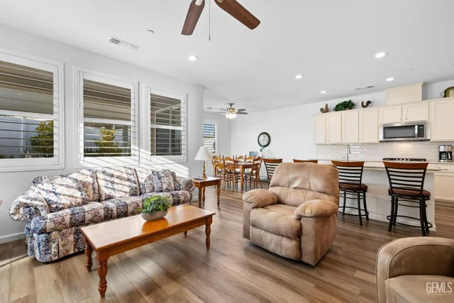 a kitchen with a sink a stove a refrigerator and cabinets