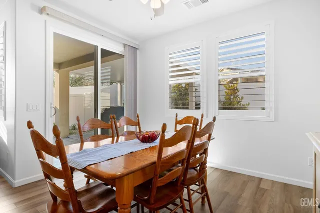 a kitchen with stainless steel appliances granite countertop a white cabinets and a stove top oven