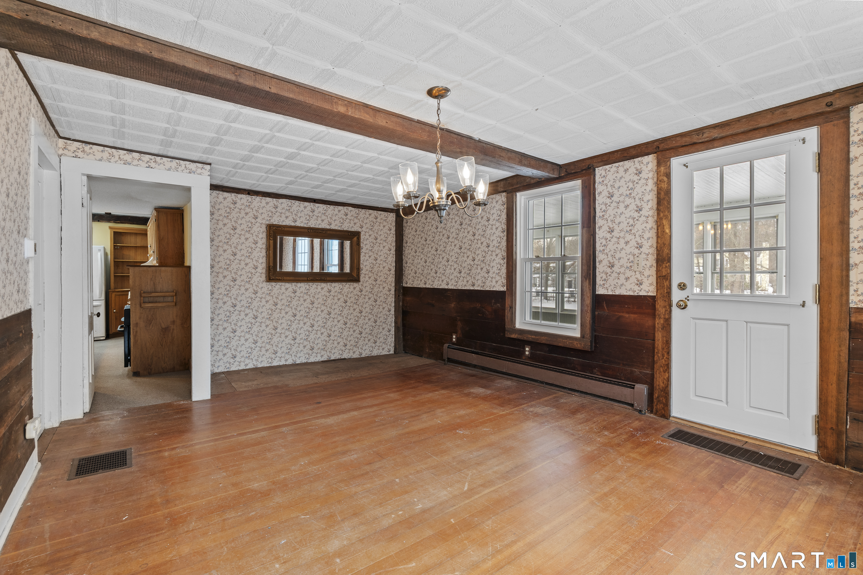 392 Boston Neck Road Suffield, CT 06078 - Photo 15 of 35 a view of an empty room with a fireplace and a window